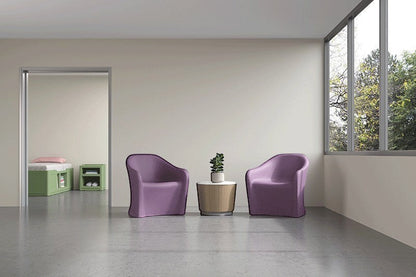 Two Flo Lounge Chairs with a Drum Table and Flo Bed and bedside table in a behavioural health patient room environment