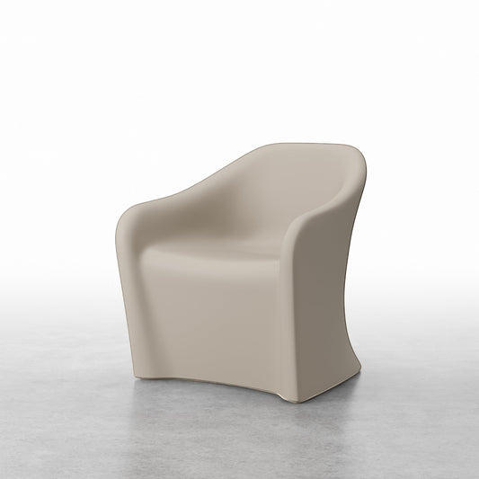 A Flo Rotomolded Lounge Chair for behavioural health in the colour Warm Sand on a concrete background