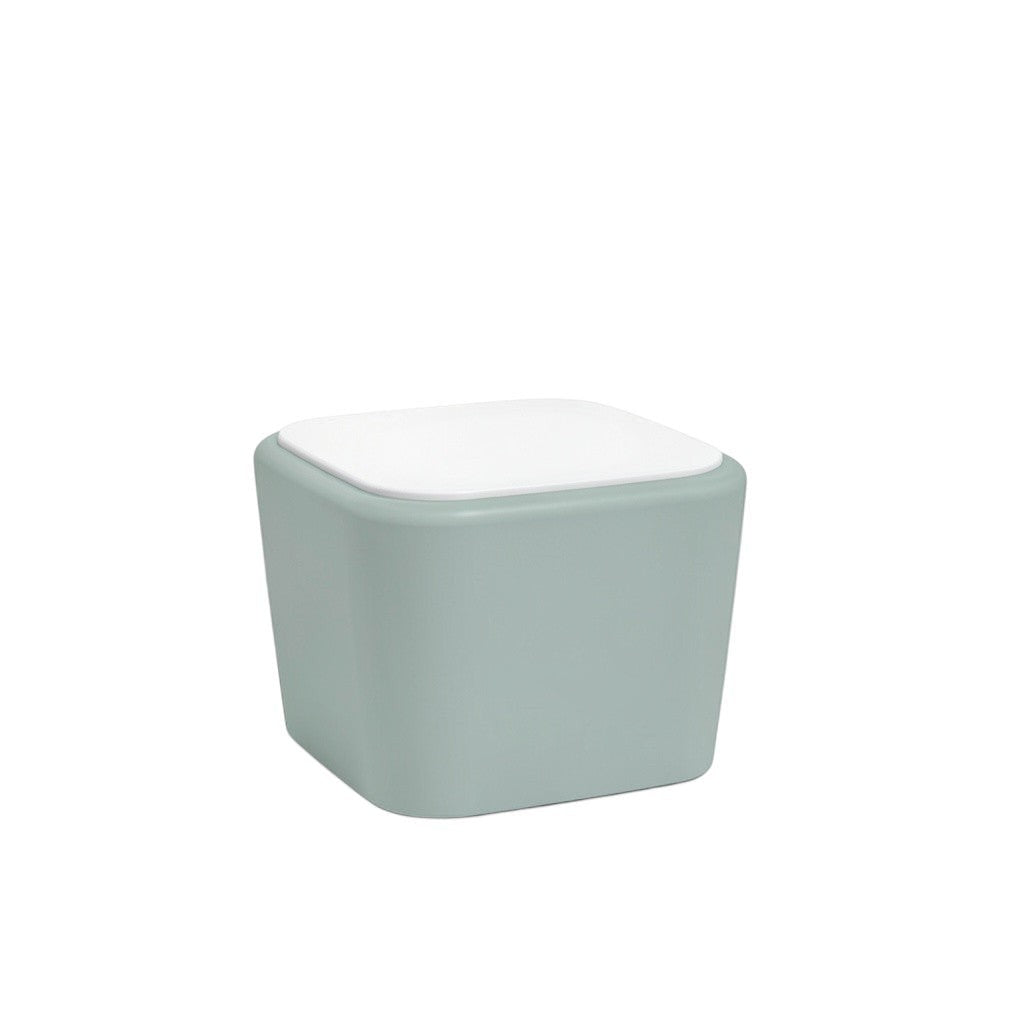Stat Medical Inc Flo BH occasional table with a sage green base and white top, featuring rounded safety edges.